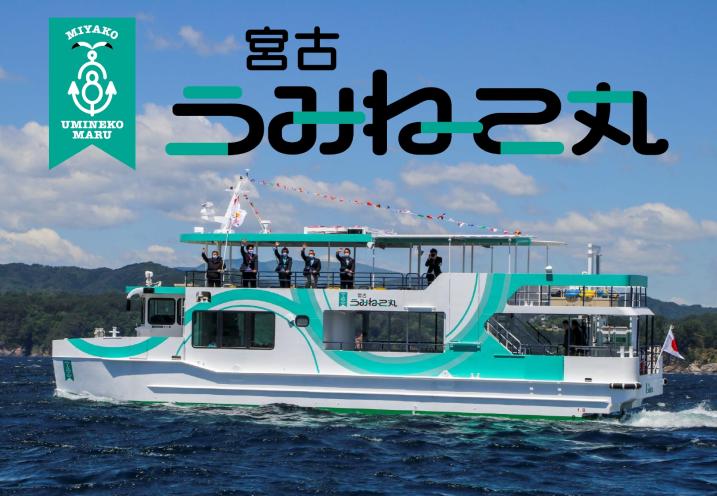 海を走る二階建ての宮古うみねこ丸の船と、船の二階部分に立ちながら船の外に向かって手を振るスーツ姿の男性達を横から写した写真(岩手県宮古市 浄土ヶ浜 遊覧船 宮古うみねこ丸のトップページへリンク)