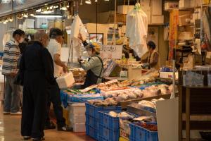 主に魚がおかれている市場で、売り買いしている人たちの写真