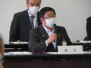 議長と書かれたネームプレートの自席で座って、話をしている市長の写真