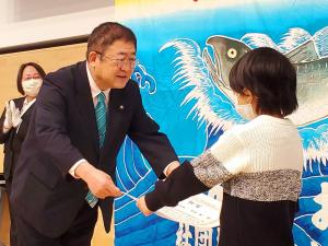入賞した小学生が市長から賞状を受け取っている「宮古鮭まつり小学生図画コンクール」の表彰式の写真