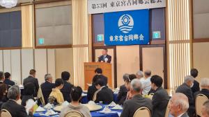 東京宮古同郷会の横断幕が掲げられたパーティー会場の壇上に立ち挨拶をする市長の写真
