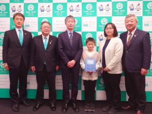 市長と最優秀賞を受賞した絵本を持った谷地隼輔さんと男女各1名の関係者の方々、副市長と他職員1人の計6人が横一列に並んでいる写真