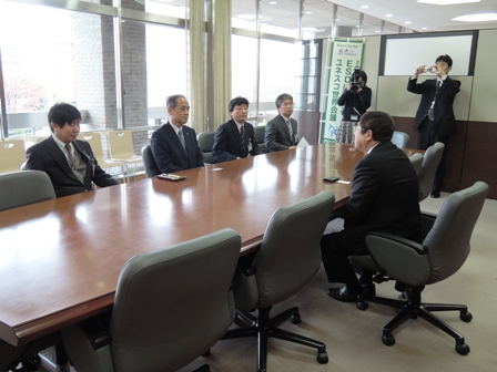 長机の席に座る市長と、向かい側に座る4名の男性の写真