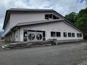 外壁がクリーム色の2階建ての建物で入口前に4段ほどの段差がある川井トレーニングセンターの外観写真