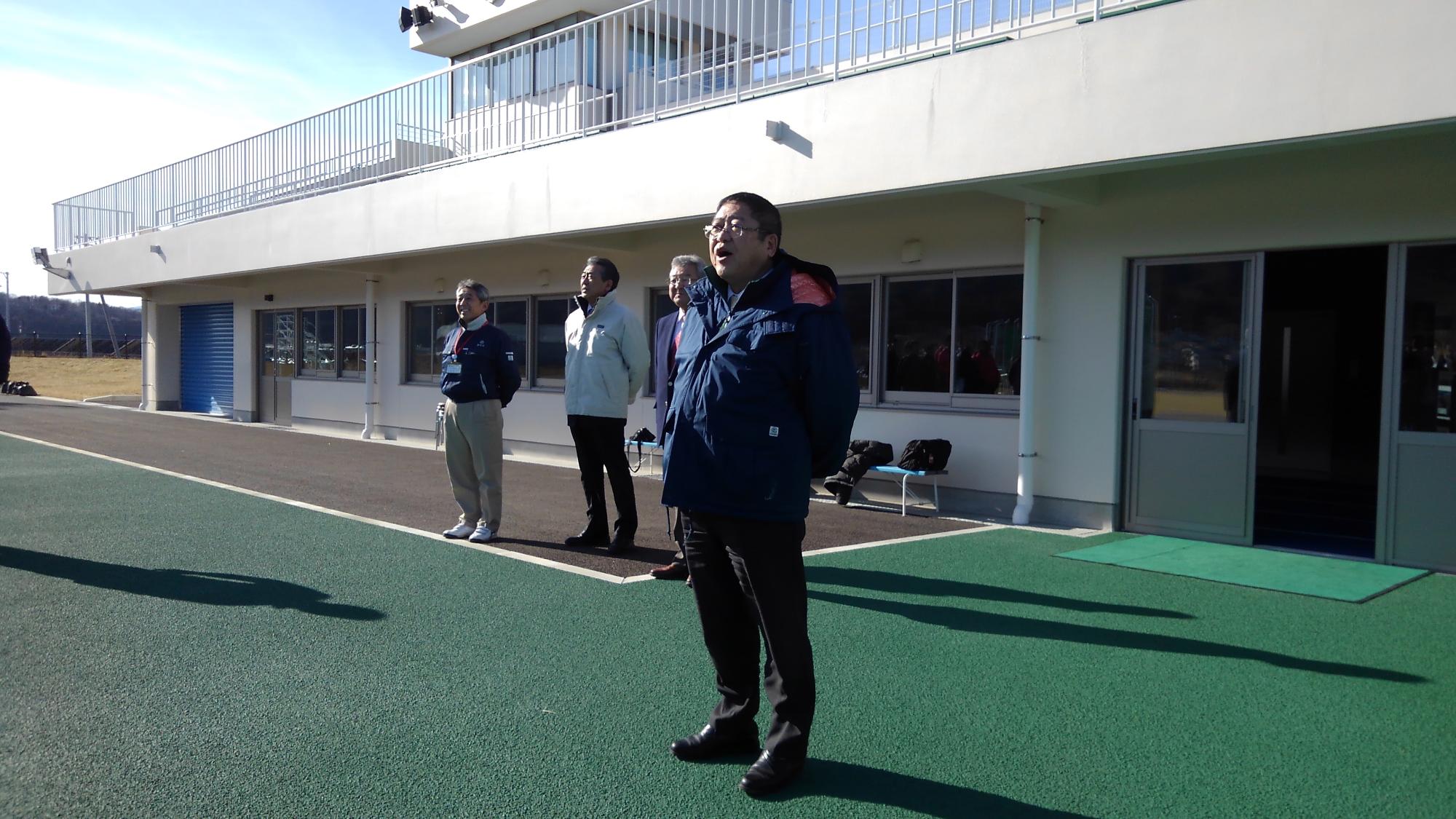 両手を後ろに組んで口を開けて話をしている様子の市長の写真