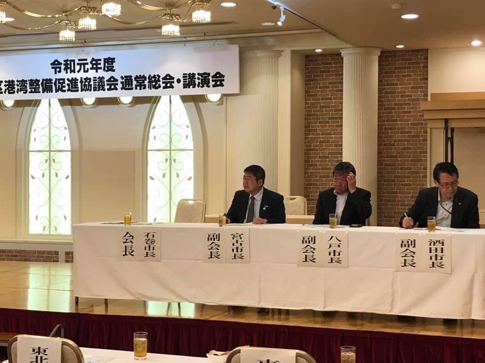「令和元年度 東北地区港湾整備促進協議会通常総会・講演会」と書かれた横断幕が掲げられた会場で、副会長に選任された八戸市長と酒田市長、市長が横並びの席に着席している総会の様子の写真