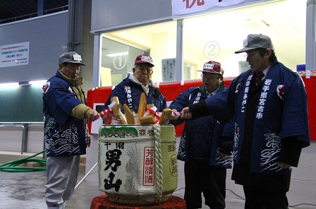日本酒の大きな樽を市長と3名の男性が一緒に鏡開きしている様子の写真